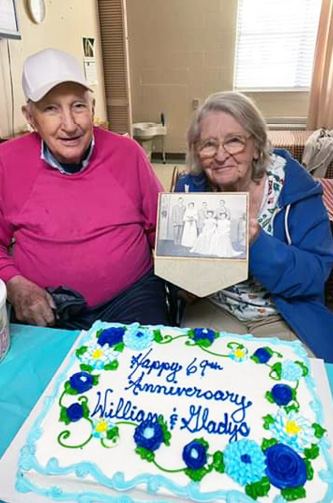 Residents William and Gladys celebrate their 69th wedding anniversary with cake and a photo of their wedding