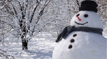 large snowman in the snow-covered woods