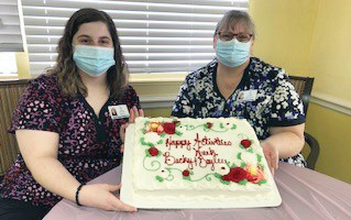 Shady Lawn Nursing and Rehab staff members with their large sheet cake