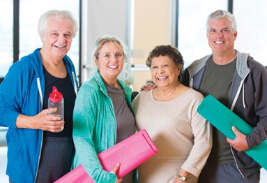 Portrait of older adults, men and women, smiling after working out.