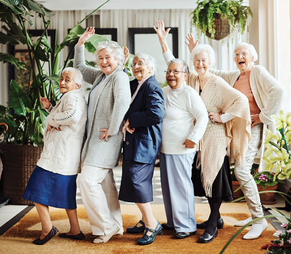 Seniors dancing in a conga line, smiling, happy